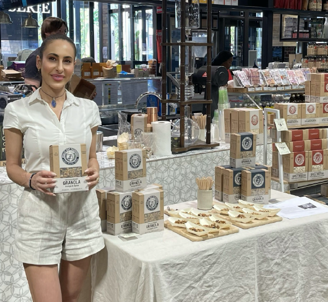 Rachael sampling granola at an in-store tasting stand